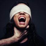 woman in black tank top with white knit cap