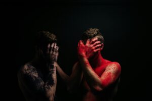 a couple of men covered in red paint