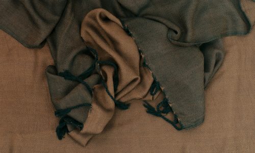 a pile of cloth sitting on top of a bed